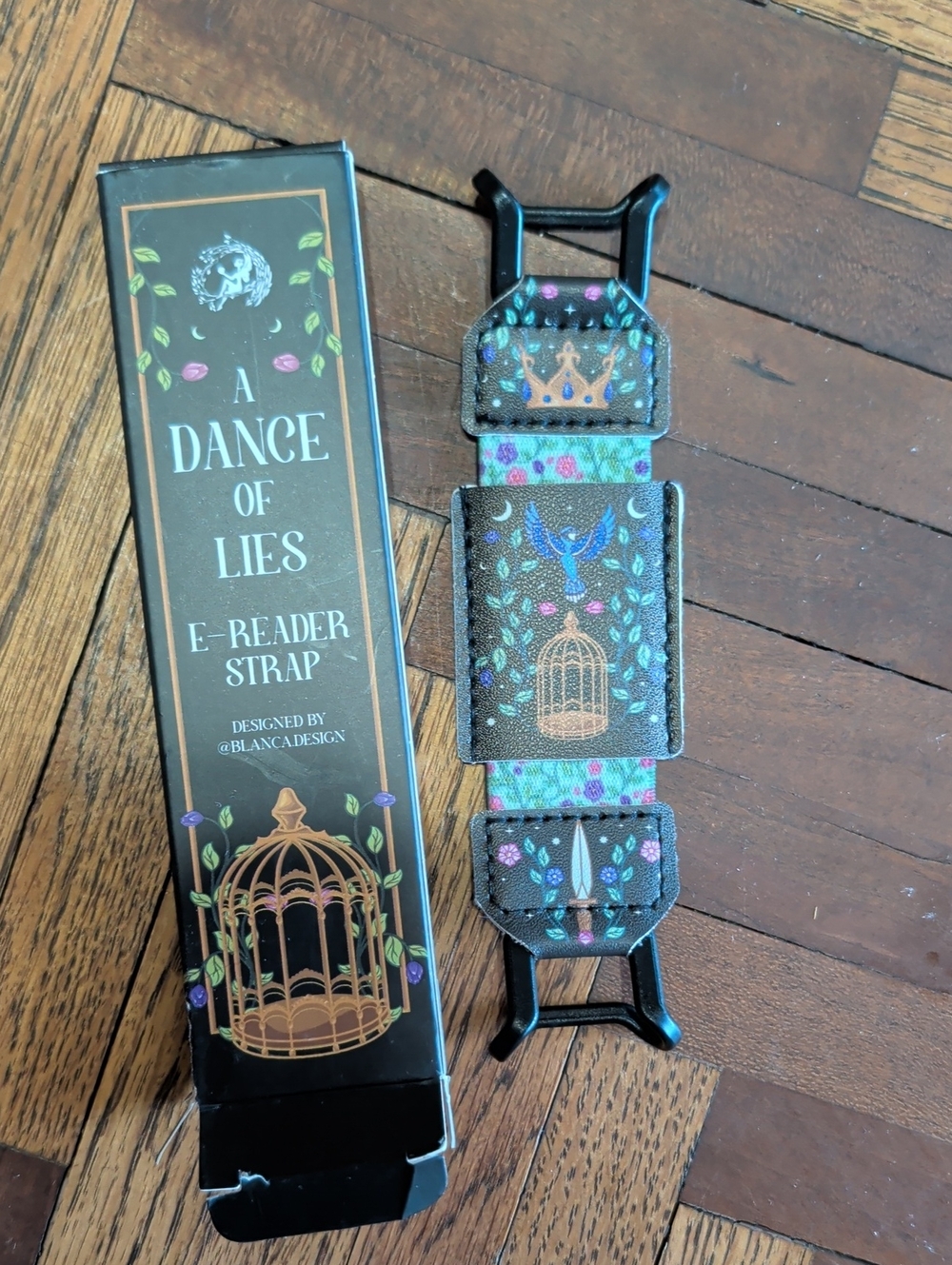 Fairyloot A Dance of Lies E-Reader Strap with Crown & Bird Motif - Brown/Teal